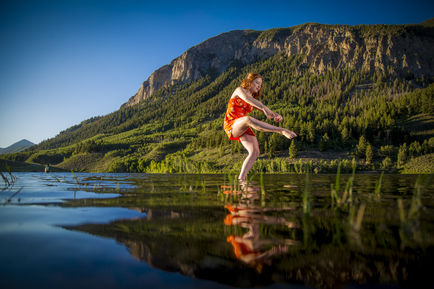 A high school senior photography session on a lake in Crested Butte Colorado with a dancer.