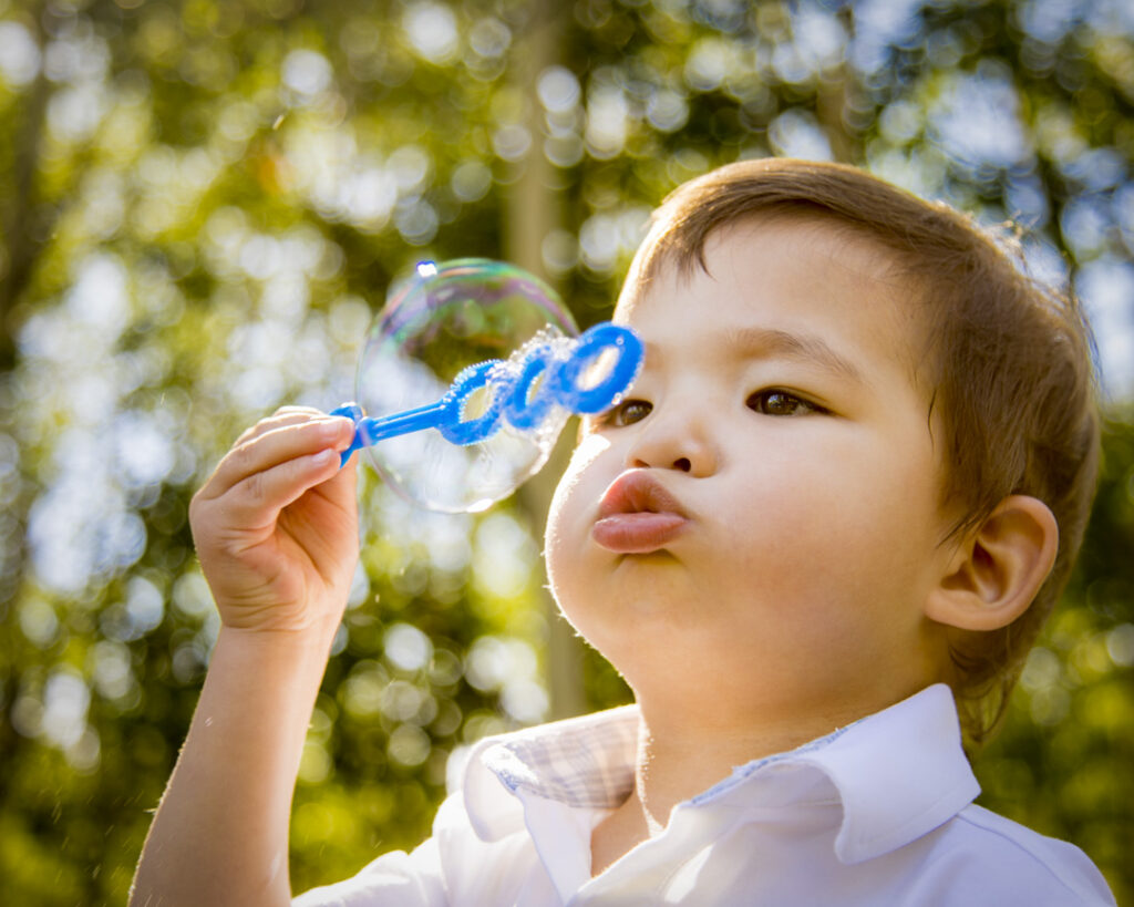 blowing bubbles in an outdoor photography session